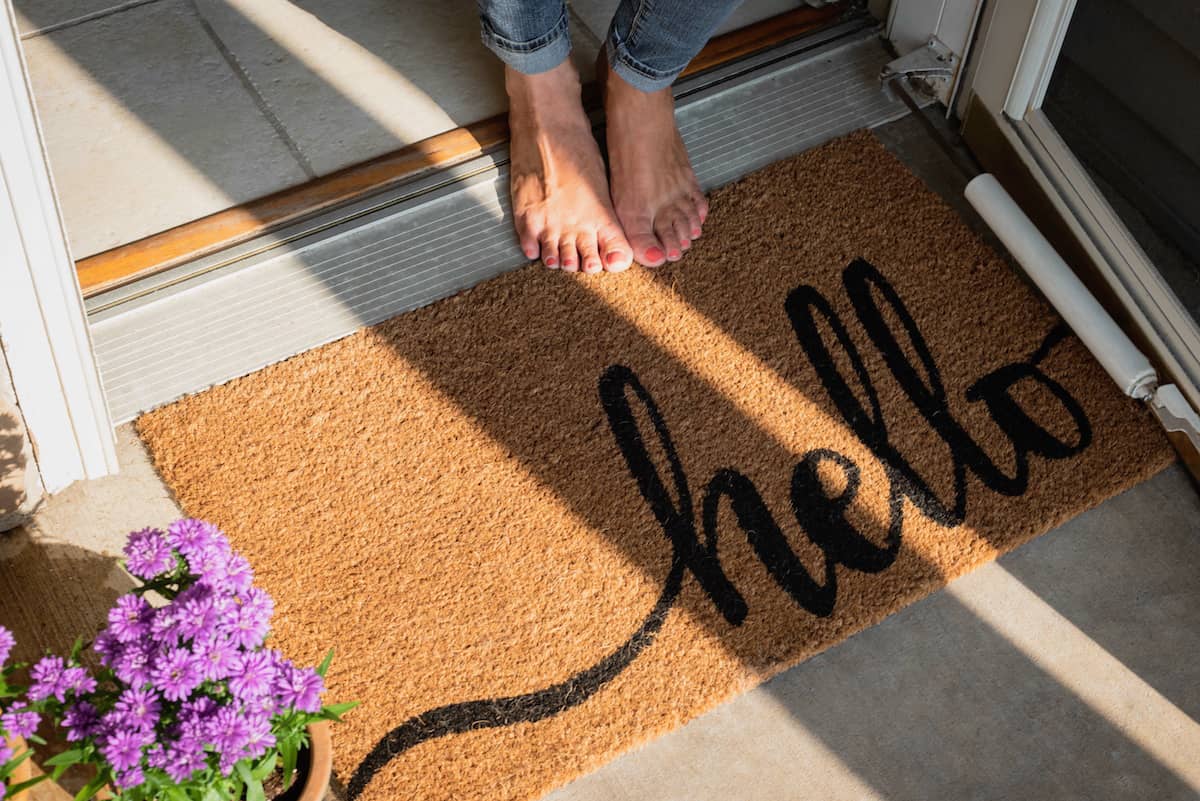 welcome mat in front of new home
