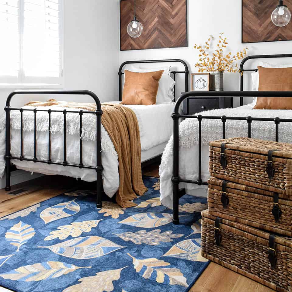 https://www.sellingandbuyingahome.com/wp-content/uploads/2022/05/5X7-rug-under-twin-beds-ruggable-Blue-and-Gold-Leaf-Rug-Under-Twin-Beds.jpg